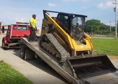 Heavy construction equipment loaded on flatbed